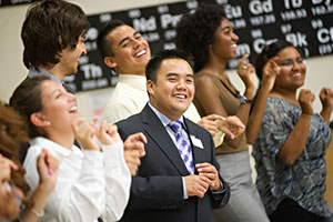 A diverse group of students laughing together at an on-campus event