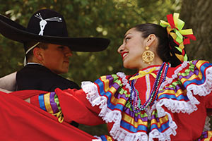 A male and a female students perform a cultural dance together