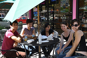 A group of students sits around a table in Downtown Davis